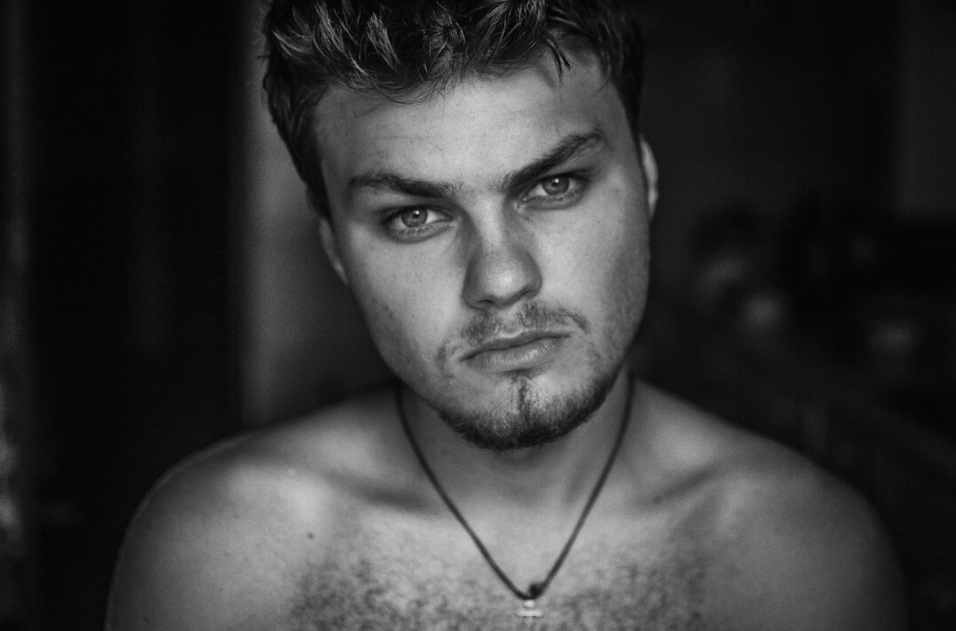 Portrait of a man with a short beard looking at the camera