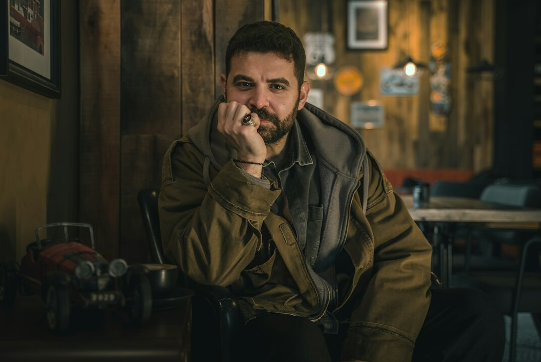 Portrait of a smiling bearded man in a casual jacket