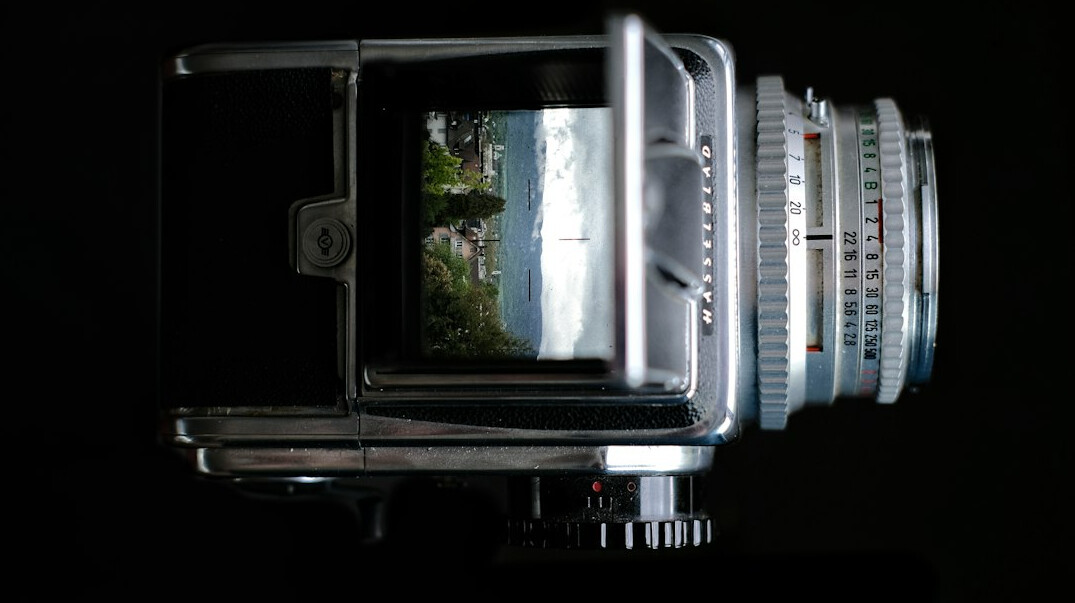 Broadcast studio camera on a pedestal under bright studio lights